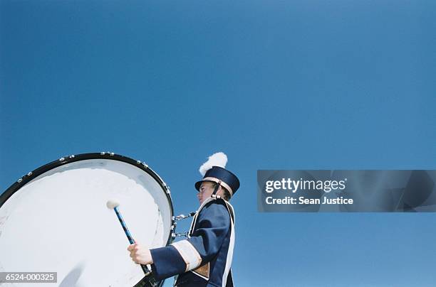 girl playing bass drum - bass drum stock-fotos und bilder