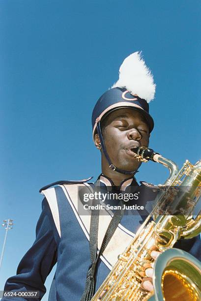 boy playing saxophone - marching band stock pictures, royalty-free photos & images