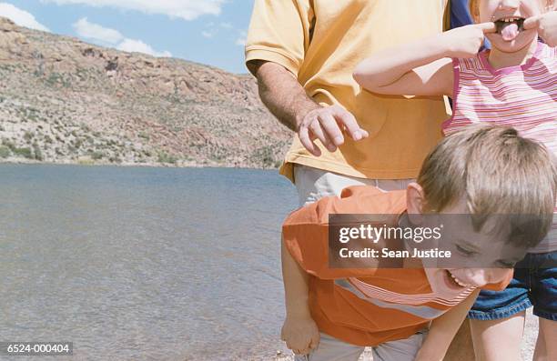 father and children playing - bending over stock pictures, royalty-free photos & images