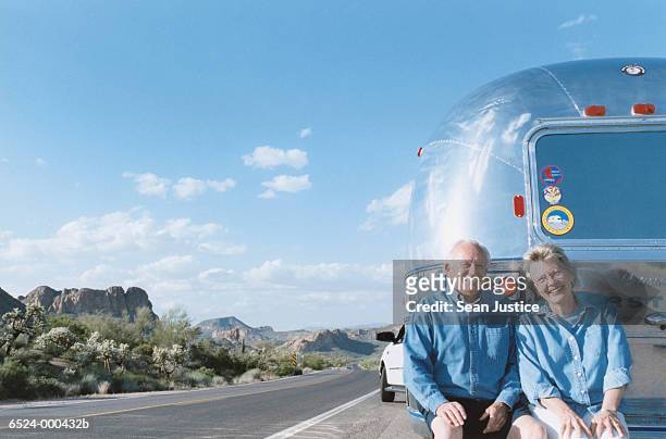 couple outside trailer home - family caravan stockfoto's en -beelden