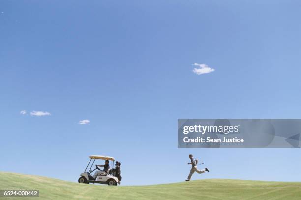 golfer chasing golf cart - golf humor stock pictures, royalty-free photos & images