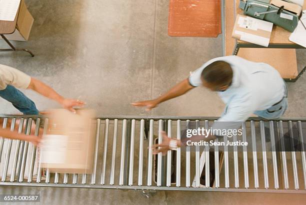 warehouse workers pack boxes - boxes conveyor belt stock-fotos und bilder