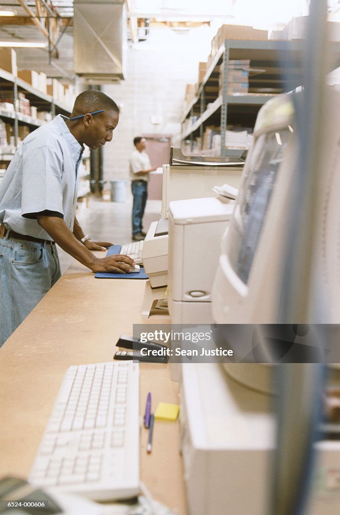 Warehouse Worker uses Computer