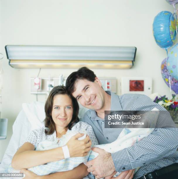 couple with new born twins - multiple birth stock pictures, royalty-free photos & images