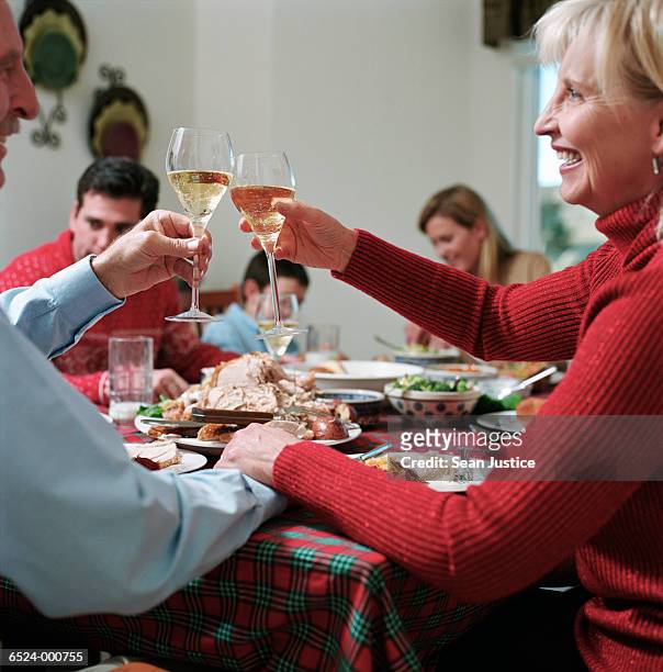 couple toasting at dinner - man and woman holding hands profile stock-fotos und bilder