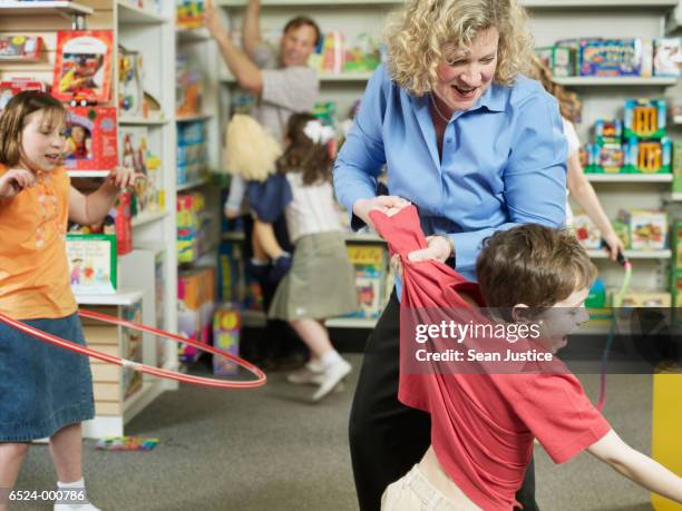 stressed parents in toy store - scolding stock pictures, royalty-free photos & images