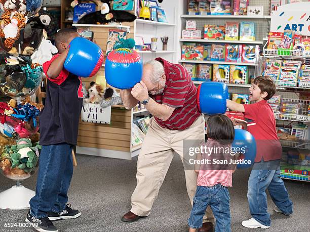 children and man in toy store - toy store stock pictures, royalty-free photos & images