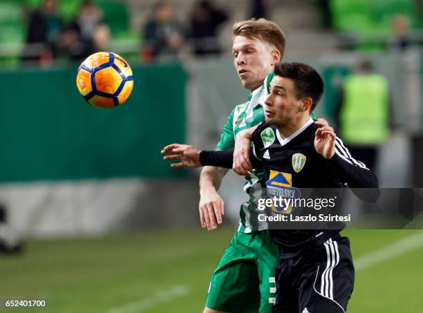 Janek Sternberg of Ferencvarosi TC duels for the ball with Barnabas Racz of Swietelsky Haladas during the Hungarian OTP Bank Liga match between...