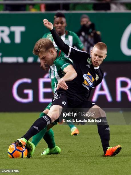 Janek Sternberg of Ferencvarosi TC fights for the ball with Lorant Kovacs of Swietelsky Haladas during the Hungarian OTP Bank Liga match between...