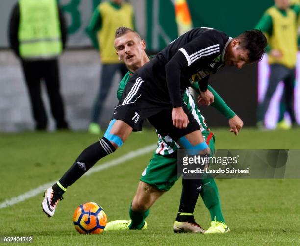 Emir Dilaver of Ferencvarosi TC fights for the ball with Peter Halmosi of Swietelsky Haladas during the Hungarian OTP Bank Liga match between...