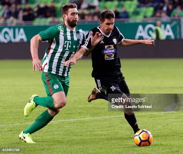 Daniel Bode of Ferencvarosi TC duels for the ball with Mark Jagodics of Swietelsky Haladas during the Hungarian OTP Bank Liga match between...