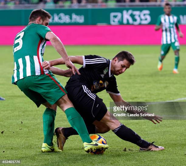 Daniel Bode of Ferencvarosi TC fights for the ball with Mark Jagodics of Swietelsky Haladas during the Hungarian OTP Bank Liga match between...