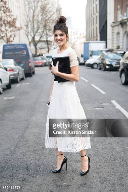Guest wears a Self Portrait dress and Christian Louboutin shoes on day 2 of London Womens Fashion Week Autumn/Winter 2017, on February 18, 2017 in...