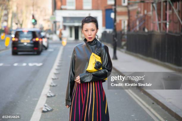 Fashion buyer Jeannie Lee wears Alice Temperley dress, Zara jacket and J.W Anderson bag on day 2 of London Womens Fashion Week Autumn/Winter 2017, on...