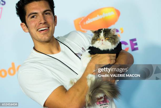 Phil the Cat from "Aaron's Animals" arrives with his owner Aaron Benitez for the 30th Annual Nickelodeon Kids' Choice Awards, March 11 at the Galen...