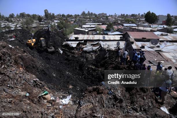 Rescue workers search for those buried by a landslide that swept through a massive garbage dump, killing at least 10 people and leaving several...