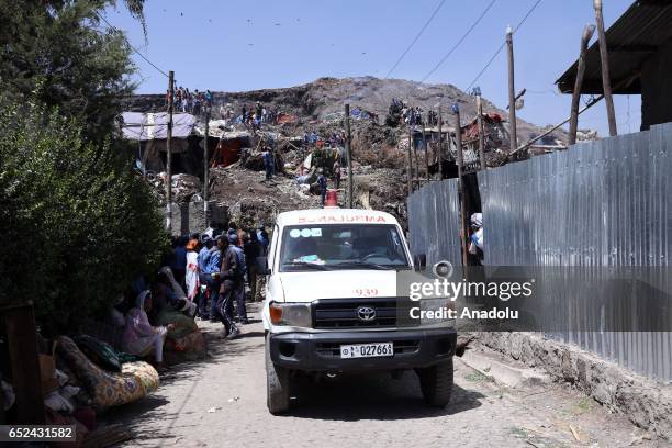 Rescue workers search for those buried by a landslide that swept through a massive garbage dump, killing at least 10 people and leaving several...