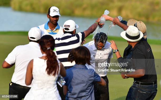 Chawrasia of India is showered in water by friends on the 18th hole during the final round of the Hero Indian Open at Dlf Golf and Country Club on...