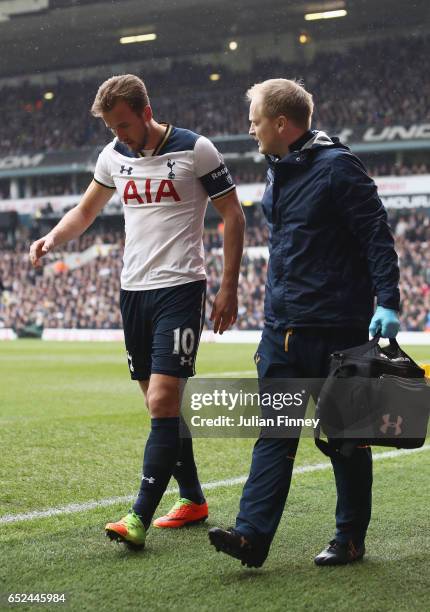 Harry Kane of Tottenham Hotspur is taken off injured during The Emirates FA Cup Quarter-Final match between Tottenham Hotspur and Millwall at White...
