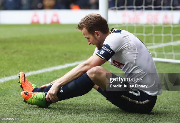 Harry Kane of Tottenham Hotspur holds his ankle during The Emirates FA Cup Quarter-Final match between Tottenham Hotspur and Millwall at White Hart...