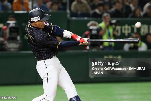 Pinch hitter Seiichi Uchikawa of Japan hits a double in the top of the tenth inning during the World Baseball Classic Pool E Game Two between Japan...