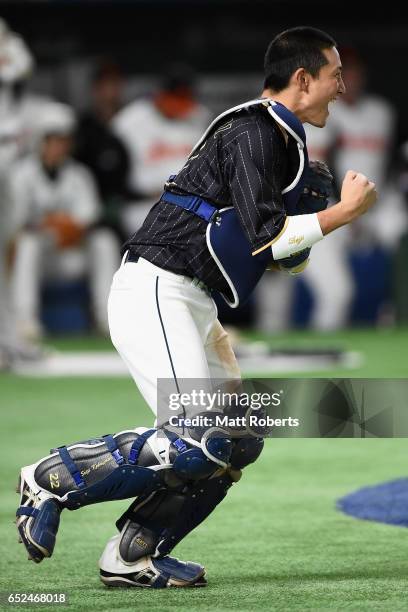 Catcher Seiji Kobayashi of Japan celebrates after catching a pop fly hit by Outfielder Kalian Sams of the Netherlands to win by 8-6 in the bottom of...