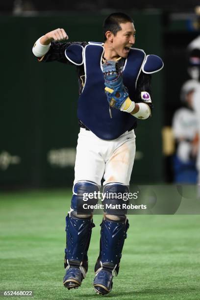 Catcher Seiji Kobayashi of Japan celebrates after catching a pop fly hit by Outfielder Kalian Sams of the Netherlands to win by 8-6 in the bottom of...