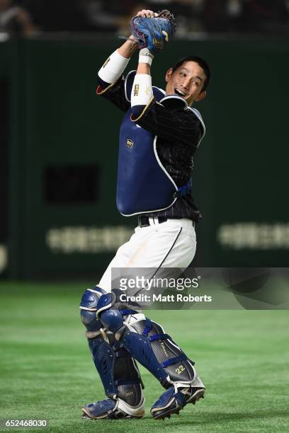 Catcher Seiji Kobayashi of Japan makes a catch a pop fly hit by Outfielder Kalian Sams of the Netherlands to win by 8-6 in the bottom of eleventh...