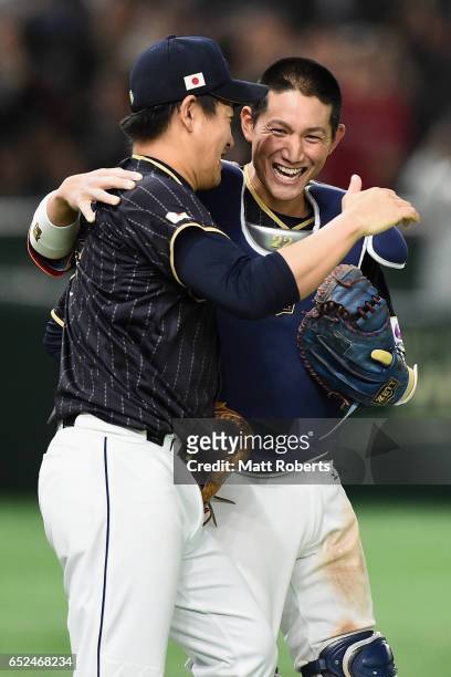 Pitcher Kazuhisa Makita and Catcher Seiji Kobayashi of Japan celebrate their 8-6 victory after the World Baseball Classic Pool E Game Two between...