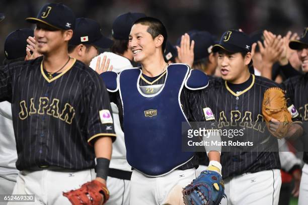 Catcher Seiji Kobayashi and Japanese players celebrate after their 8-6 victory in the World Baseball Classic Pool E Game Two between Japan and...