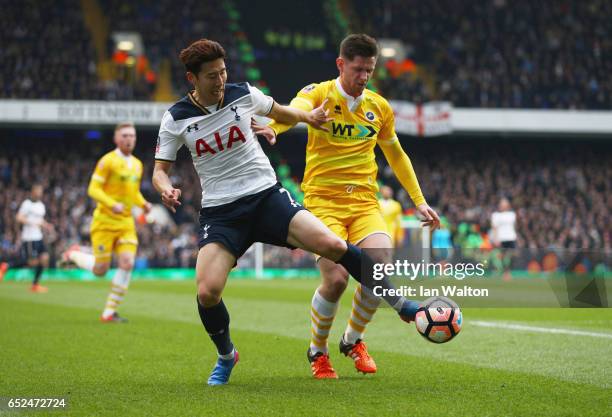 Heung-Min Son of Tottenham Hotspur battles with Calum Butcher of Millwall during The Emirates FA Cup Quarter-Final match between Tottenham Hotspur...