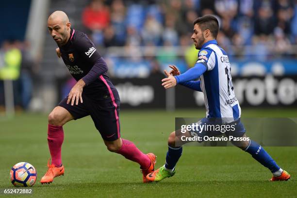 Carles Gil of RC Deportivo La Coruna competes for the ball with Javier Mascherano of FC Barcelona during the La Liga match between RC Deportivo La...