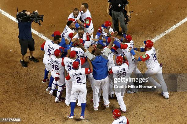 Nelson Cruz of the Dominican Republic is congratulated after hitting a three run home run during the eighth inning of a Pool C game of the 2017 World...