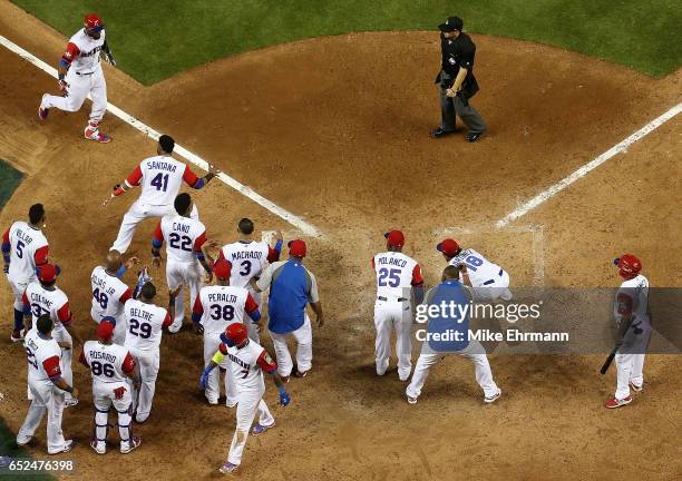 Starling Marte of the Dominican Republic is congratulated after hitting a solo home run during the eighth inning of a Pool C game of the 2017 World...