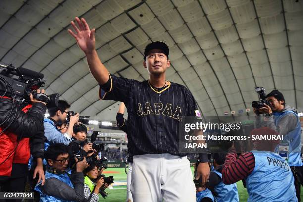 Infielder Sho Nakata of Japan applauds fans after the World Baseball Classic Pool E Game Two between Japan and Netherlands at the Tokyo Dome on March...