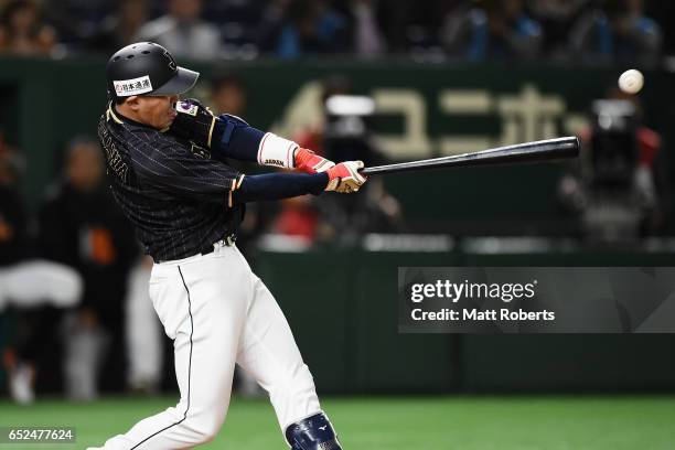 Pinch hitter Seiichi Uchikawa of Japan hits a double in the top of the tenth inning during the World Baseball Classic Pool E Game Two between Japan...