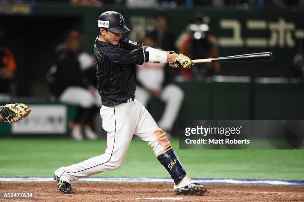 Catcher Seiji Kobayashi of Japan hits a double in the top of tenth inning during the World Baseball Classic Pool E Game Two between Japan and...