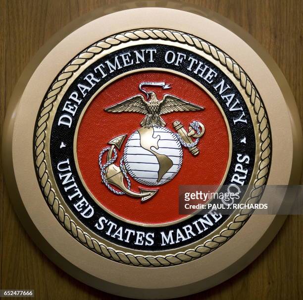 The US Department of the Navy, US Marine Corps, seal hangs on the wall February 24 at the Pentagon in Washington,DC. AFP Photo/Paul J. Richards / AFP...