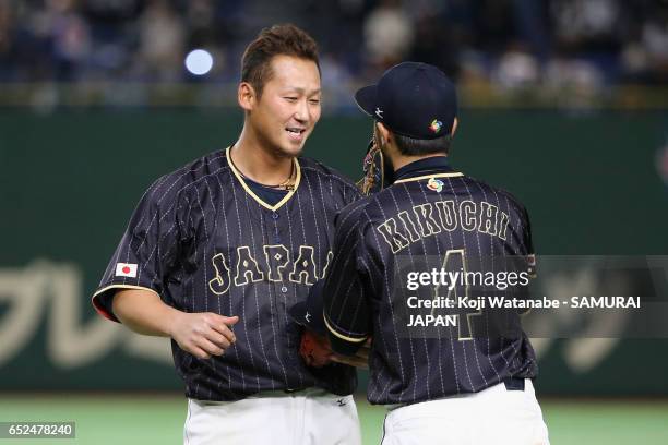 Infielder Sho Nakata of Japan celebrates with Ryosuke Kikuchi hitting a two run single after the top of eleventh inning during the World Baseball...