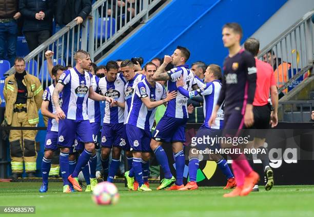 Deportivo La Coruna's forward Joselu celebrates with teammates after scoring during the Spanish league football match RC Deportivo de la Coruna vs FC...