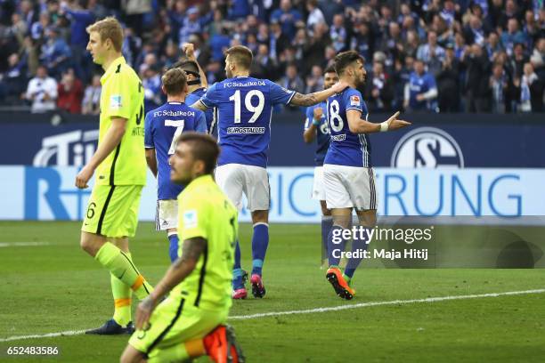 Guido Burgstaller of Schalke celebrates the second team goal with his team mate Daniel Caligiuri whilst Konstatntinos Stafylidis of Augsburg looks...