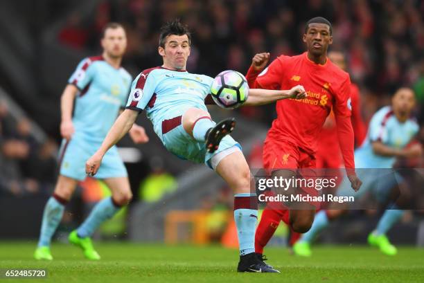 Joey Barton of Burnley beats Georginio Wijnaldum of Liverpool to the ball during the Premier League match between Liverpool and Burnley at Anfield on...