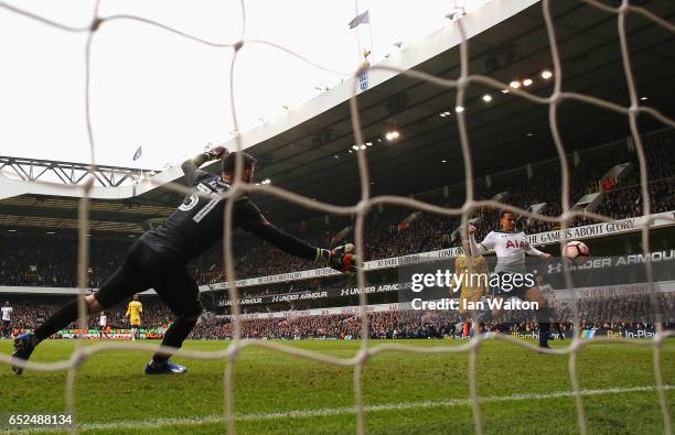 Dele Alli of Tottenham Hotspur scores his sides fourth goal past Tom King of Millwall during The Emirates FA Cup Quarter-Final match between...