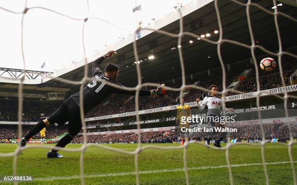 Dele Alli of Tottenham Hotspur scores his sides fourth goal past Tom King of Millwall during The Emirates FA Cup Quarter-Final match between...