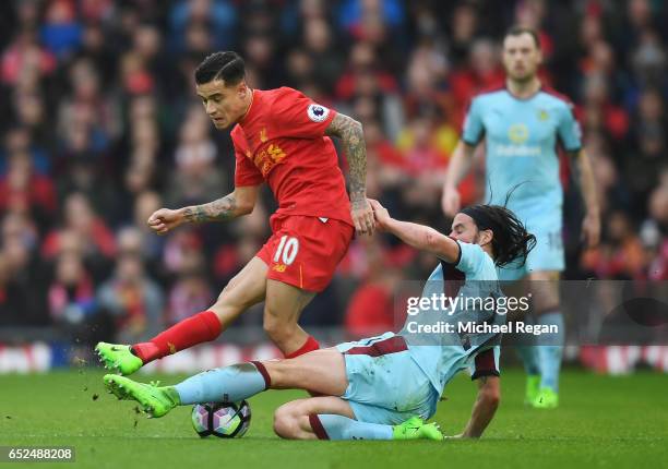 Philippe Coutinho of Liverpool is tackled by George Boyd of Burnley during the Premier League match between Liverpool and Burnley at Anfield on March...