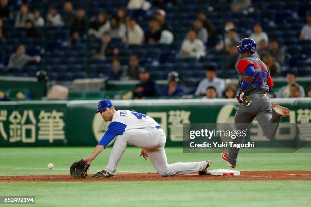 Yurisbel Gracial of Team Cuba beats the throw to first base as Nate Freiman of Team Israel waits for the throw during Game 1 of Pool E at the Tokyo...