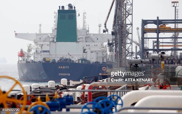 Picture taken on March 12 shows an Panamanian tanker docking at the platform of the oil facility in the Khark Island, on the shore of the Gulf.