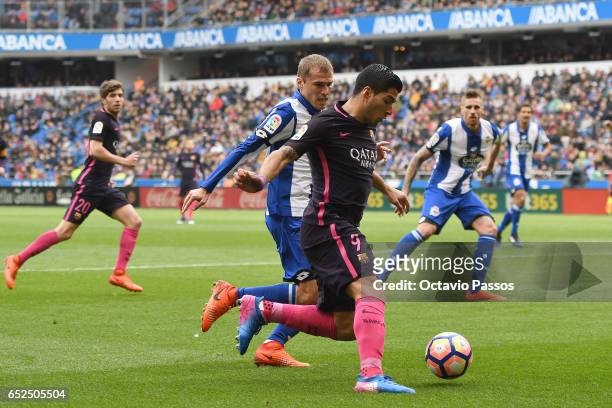 Alex Bergantinos of RC Deportivo La Coruna competes for the ball with Luis Suarez of FC Barcelona during the La Liga match between RC Deportivo La...