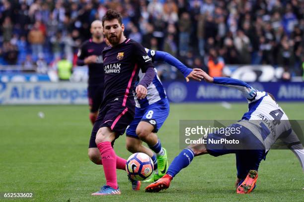 Leo Messi forward of FC Barcelona battles for the ball with Alex Bergantiños midfielder of Deportivo de La Coruña and Emre Çolak midfielder of...