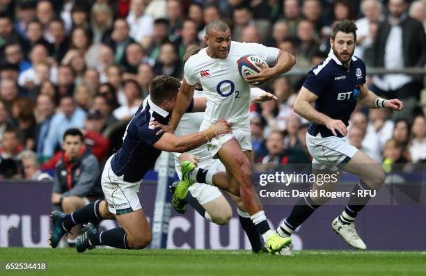 Jonathan Joseph of England is tackled by Huw Jones during the RBS Six Nations match between England and Scotland at Twickenham Stadium on March 11,...